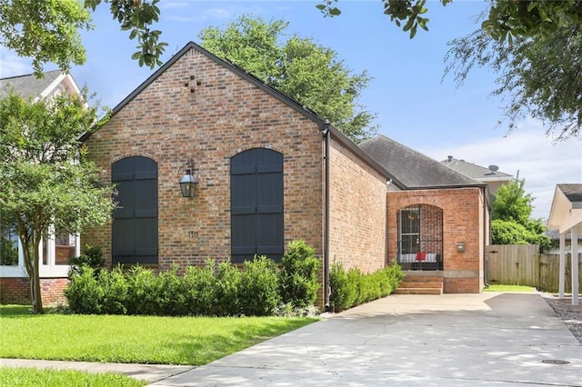 110 Sharon Dr, New Orleans, LA 70124 - french country home featuring brick siding and roof with shingles