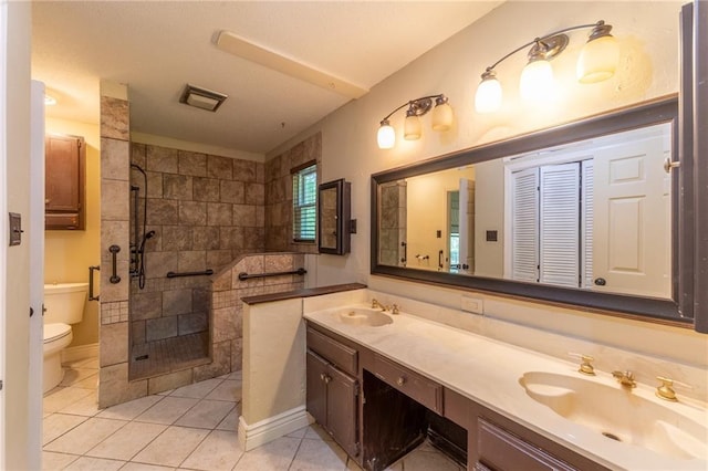 20408 Smith Rd, Covington, LA 70435 - full bathroom with toilet, double vanity, walk in shower, and tile patterned floors