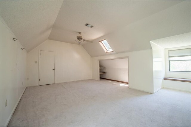 20408 Smith Rd, Covington, LA 70435 - bonus room featuring light colored carpet, lofted ceiling, a skylight, ceiling fan, and healthy amount of natural light