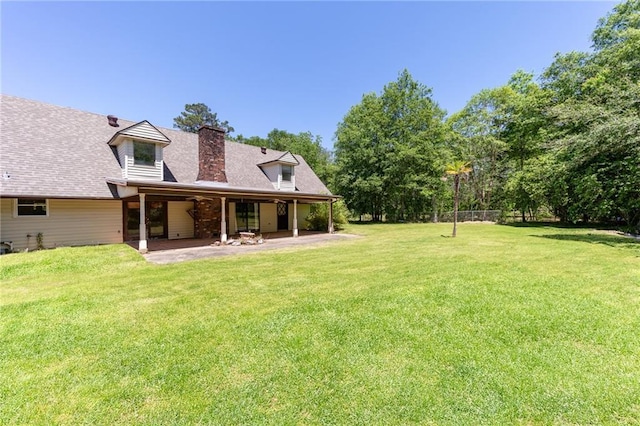 20408 Smith Rd, Covington, LA 70435 - back of property featuring a patio area, a yard, a chimney, and roof with shingles