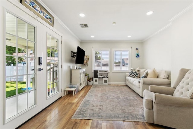 living room featuring ornamental molding, wood finished floors, baseboards, recessed lighting, and french doors