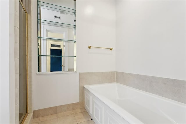 1215 Exposition Blvd, New Orleans, LA 70118 - full bathroom with a bath, tile patterned flooring, and a tile shower