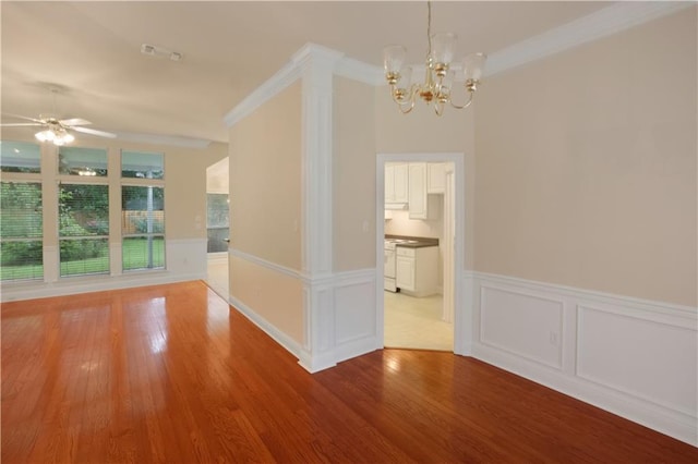 910 Crestwood Blvd, Covington, LA 70433 - unfurnished dining area with a chandelier, wood finished floors, a wainscoted wall, a ceiling fan, and ornamental molding