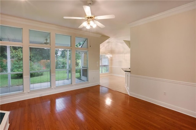 910 Crestwood Blvd, Covington, LA 70433 - unfurnished living room with a ceiling fan, wood finished floors, baseboards, ornamental molding, and a chandelier