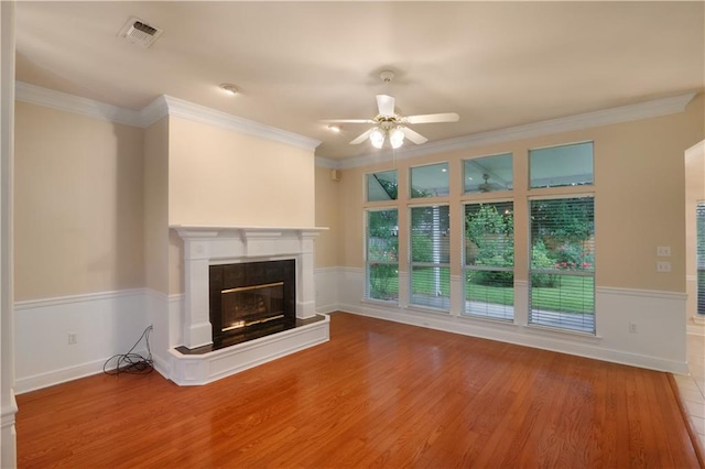 910 Crestwood Blvd, Covington, LA 70433 - unfurnished living room featuring a premium fireplace, ceiling fan, wood finished floors, and ornamental molding
