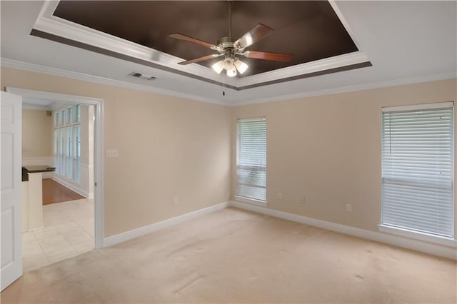910 Crestwood Blvd, Covington, LA 70433 - unfurnished room with a raised ceiling, a ceiling fan, crown molding, light colored carpet, and baseboards