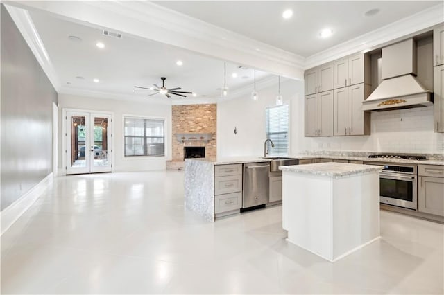 428 Hesper Ave, Metairie, LA 70005 - kitchen featuring gray cabinetry, premium range hood, stainless steel appliances, crown molding, and healthy amount of natural light