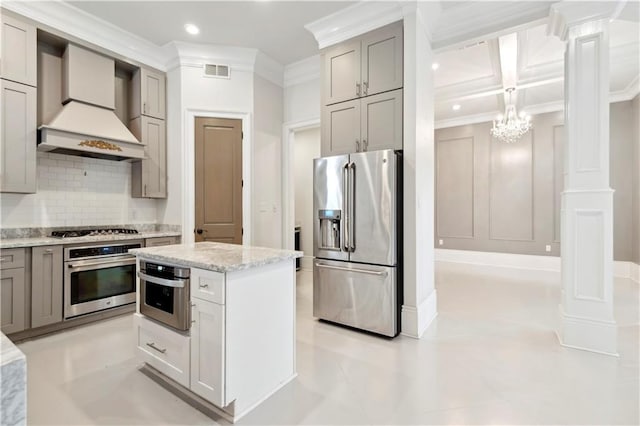 428 Hesper Ave, Metairie, LA 70005 - kitchen with stainless steel appliances, custom exhaust hood, gray cabinets, ornamental molding, and backsplash