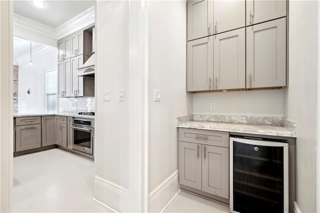 428 Hesper Ave, Metairie, LA 70005 - bar area featuring wine cooler, stainless steel appliances, crown molding, and tasteful backsplash