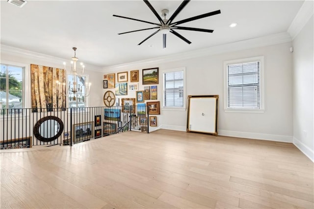428 Hesper Ave, Metairie, LA 70005 - living room featuring a chandelier, ceiling fan, healthy amount of natural light, baseboards, and crown molding