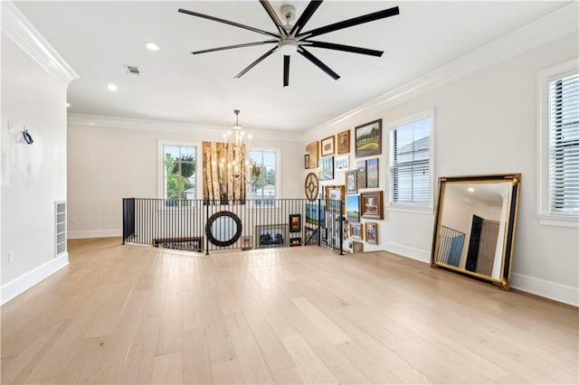 428 Hesper Ave, Metairie, LA 70005 - exercise room featuring a chandelier, crown molding, a ceiling fan, baseboards, and light wood finished floors