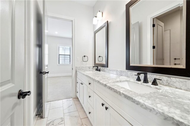 428 Hesper Ave, Metairie, LA 70005 - bathroom with marble finish flooring, baseboards, and double vanity