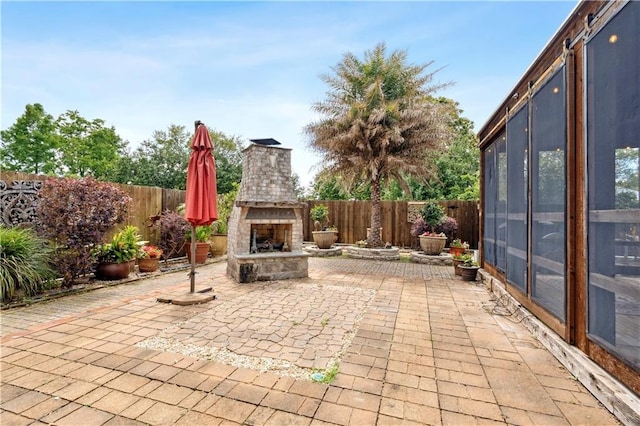 428 Hesper Ave, Metairie, LA 70005 - view of patio featuring an outdoor stone fireplace and a fenced backyard