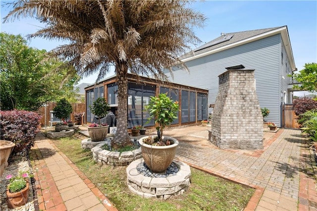 428 Hesper Ave, Metairie, LA 70005 - rear view of house with a sunroom, fence, and a patio area