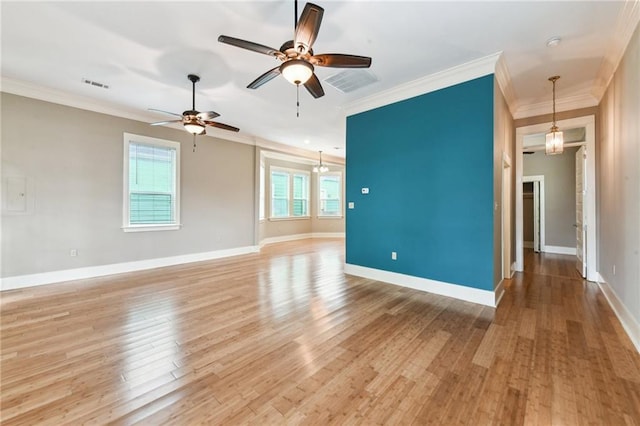 spare room with light wood-type flooring, ceiling fan, crown molding, and baseboards