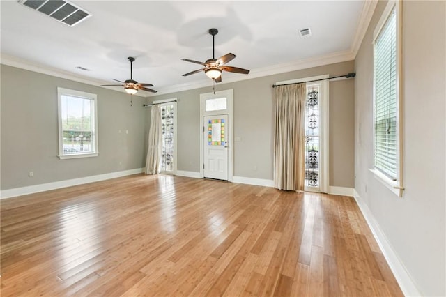 unfurnished living room featuring crown molding, ceiling fan, light wood-style floors, and baseboards