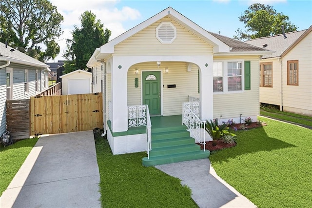 3725 Clermont Dr, New Orleans, LA 70122 - view of front of home with a front yard, a porch, and a gate