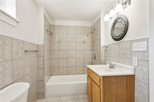 3725 Clermont Dr, New Orleans, LA 70122 - bathroom with tile walls, bathing tub / shower combination, tile patterned flooring, toilet, and a wainscoted wall