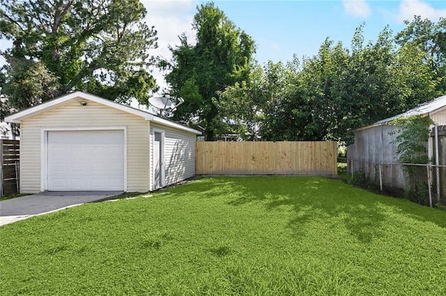 3725 Clermont Dr, New Orleans, LA 70122 - view of yard featuring an outdoor structure, a detached garage, and concrete driveway