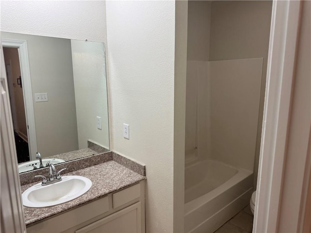 710 E Boyd Dr Unit 906, Baton Rouge, LA 70808 - bathroom with vanity, tile patterned floors, toilet, tub / shower combination, and a textured wall