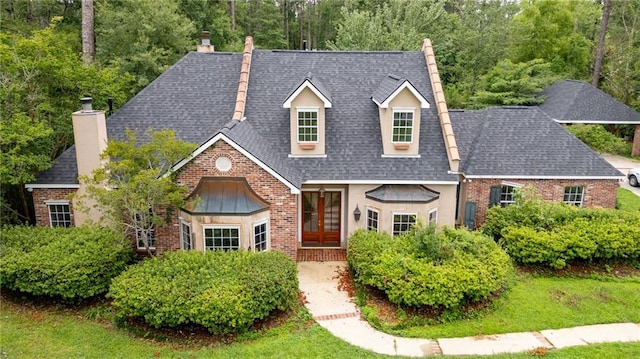 324 Salem Dr, Mandeville, LA 70471 - view of front of home featuring french doors, a chimney, brick siding, and roof with shingles