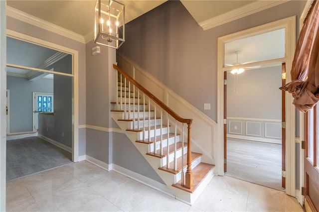 324 Salem Dr, Mandeville, LA 70471 - stairway with ornamental molding, a chandelier, ceiling fan, and tile patterned flooring