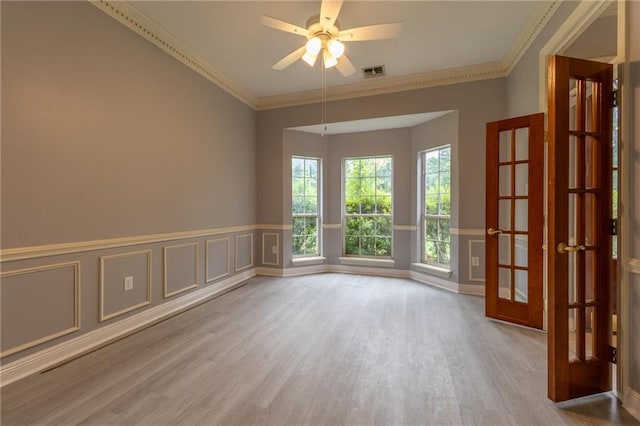 324 Salem Dr, Mandeville, LA 70471 - unfurnished room featuring wood finished floors, a decorative wall, wainscoting, ceiling fan, and crown molding