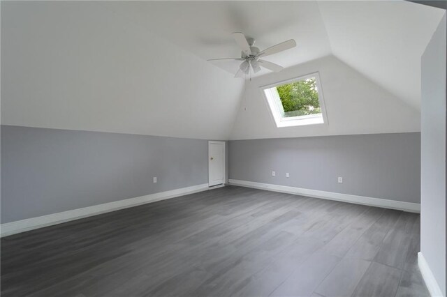 324 Salem Dr, Mandeville, LA 70471 - bonus room featuring a skylight, vaulted ceiling, a ceiling fan, dark wood-style flooring, and baseboards