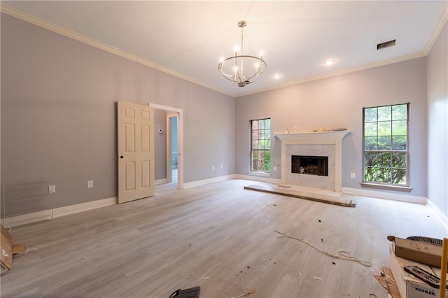 324 Salem Dr, Mandeville, LA 70471 - unfurnished living room with a chandelier, crown molding, wood finished floors, baseboards, and a premium fireplace