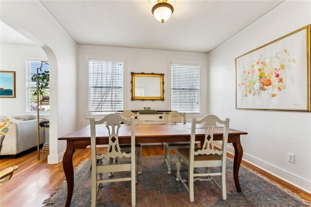 6817 Catina St, New Orleans, LA 70124 - dining space with wood finished floors, baseboards, and arched walkways