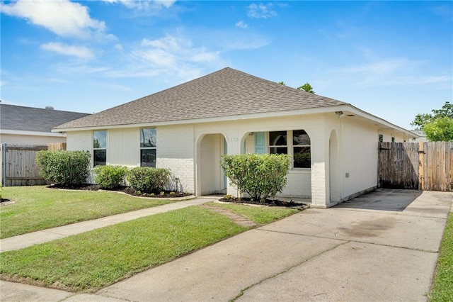 172 Winnona Dr, Westwego, LA 70094 - view of front facade featuring a shingled roof, brick siding, and concrete driveway
