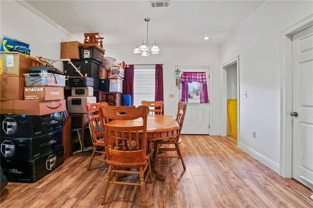 52125 Oak Ridge Dr, Franklinton, LA 70438 - dining area with a chandelier, wood finished floors, crown molding, and baseboards