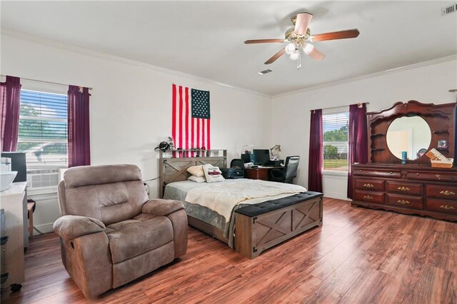 52125 Oak Ridge Dr, Franklinton, LA 70438 - bedroom with multiple windows, ornamental molding, wood finished floors, and ceiling fan