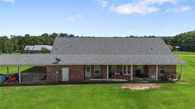 52125 Oak Ridge Dr, Franklinton, LA 70438 - back of house with a patio, a lawn, roof with shingles, and brick siding