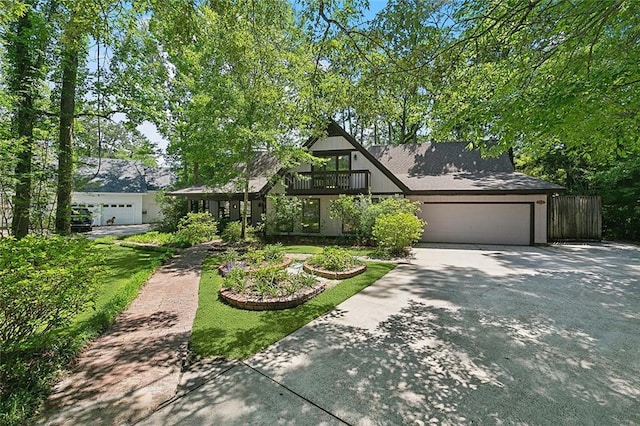 201 Natchez Pl, Mandeville, LA 70471 - view of front of house featuring driveway, a garage, a balcony, and fence