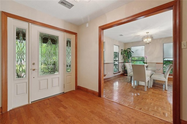 201 Natchez Pl, Mandeville, LA 70471 - entryway featuring a chandelier, baseboards, and wood finished floors