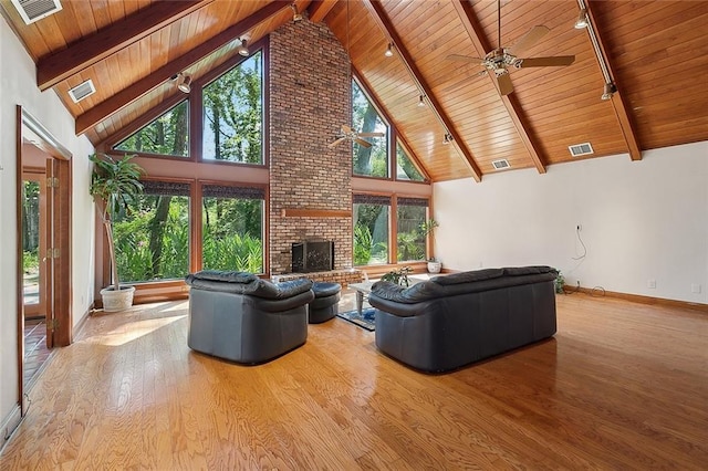 201 Natchez Pl, Mandeville, LA 70471 - living room featuring rail lighting, wooden ceiling, ceiling fan, wood finished floors, and a fireplace
