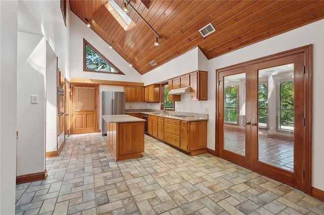 201 Natchez Pl, Mandeville, LA 70471 - kitchen with baseboards, appliances with stainless steel finishes, french doors, light countertops, and wood ceiling