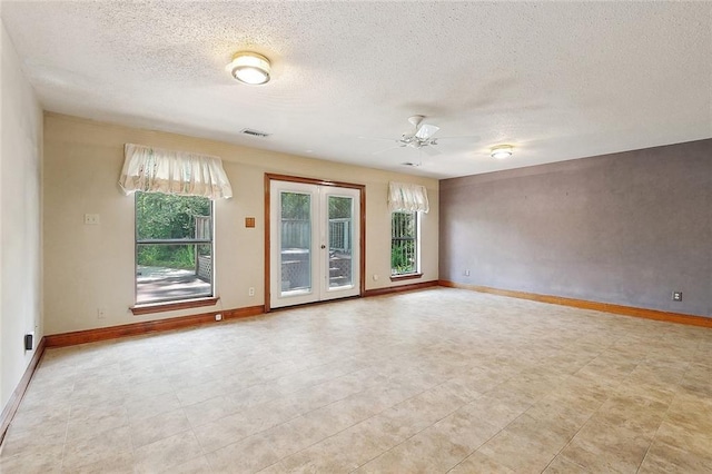 201 Natchez Pl, Mandeville, LA 70471 - unfurnished room with a ceiling fan, a textured ceiling, baseboards, and french doors