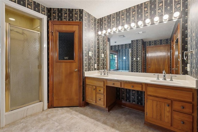 201 Natchez Pl, Mandeville, LA 70471 - bathroom featuring wallpapered walls, a shower stall, double vanity, and tile patterned flooring