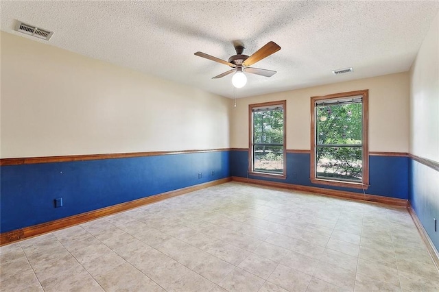 201 Natchez Pl, Mandeville, LA 70471 - empty room with a ceiling fan, a textured ceiling, baseboards, and tile patterned flooring