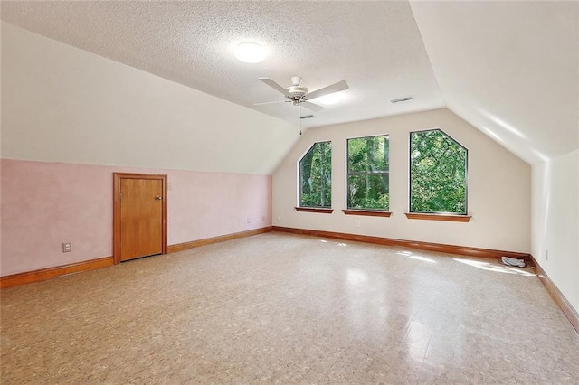 201 Natchez Pl, Mandeville, LA 70471 - bonus room with a ceiling fan, lofted ceiling, baseboards, and a textured ceiling