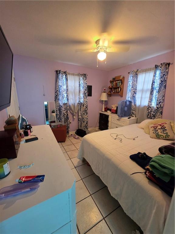 1309 Independence St, New Orleans, LA 70117 - bedroom with light tile patterned floors and ceiling fan