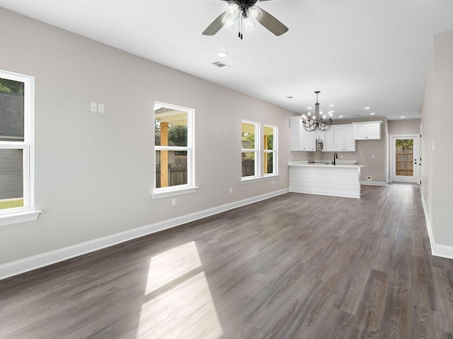 70405 9th St, Covington, LA 70433 - unfurnished living room featuring a chandelier, baseboards, recessed lighting, dark wood finished floors, and a ceiling fan