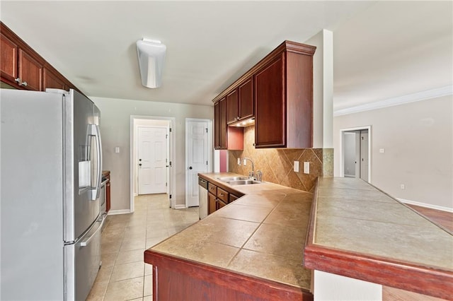 28475 Apple Blossom Ln, Ponchatoula, LA 70454 - kitchen featuring freestanding refrigerator, a sink, backsplash, a peninsula, and light tile patterned floors