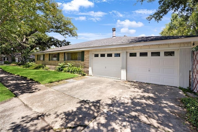 ranch-style home with concrete driveway, a garage, a front yard, and brick siding