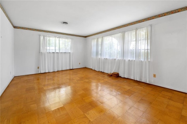 unfurnished room with baseboards