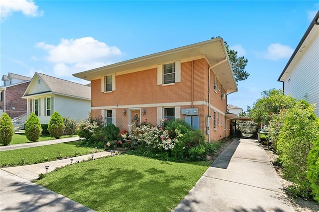 402 28th St, New Orleans, LA 70124 - traditional-style house with brick siding, a front lawn, and driveway