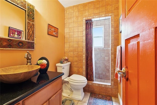 402 28th St, New Orleans, LA 70124 - bathroom featuring toilet, vanity, a tile shower, and tile patterned floors