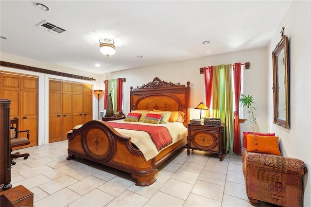 402 28th St, New Orleans, LA 70124 - bedroom featuring light tile patterned floors, recessed lighting, and multiple closets